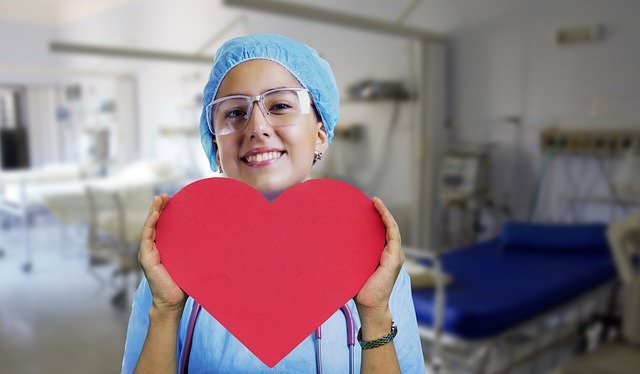 Nurse holding a healthy heart